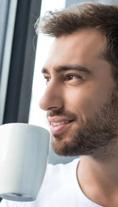 depositphotos_168744726-stock-photo-smiling-man-drinking-coffee